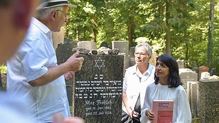 Landtagspräsidentin Aras spricht mit dem Vorstandsvorsitzenden des Vereins Ehemalige Synagoge Rexingen e.V., Heinz Högerle, auf dem Jüdischen Friedhof in Rexingen