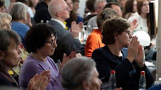 Publikum im Kaffeehaus applaudiert.