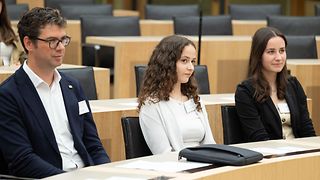 Die Preisträgerinnen und der Beiratsvorsitzende hören der Rede zu