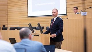 Der Staatssekretär im Bundesverteidigungsministerium, Nils Hilmer, spricht zu den Gästen. 